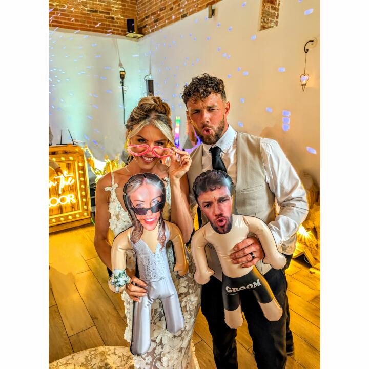 bride and groom posing with inflatable versions of themselves